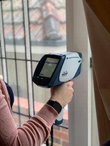 portable XRF analysing a wall