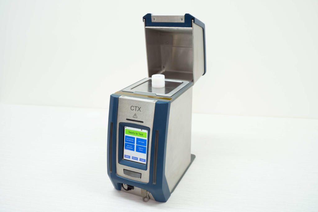 CounterTop XRF with lid open and Certified Reference Material on stage